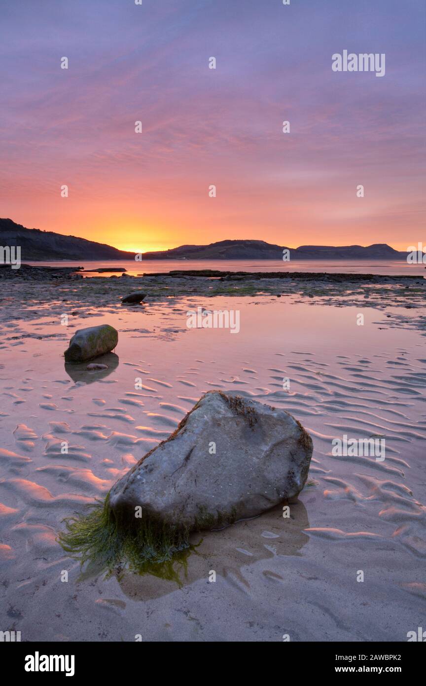 Sunrise over Lyme Bay with Golden Cap, Jurassic Coast, Dorset, England Stock Photo