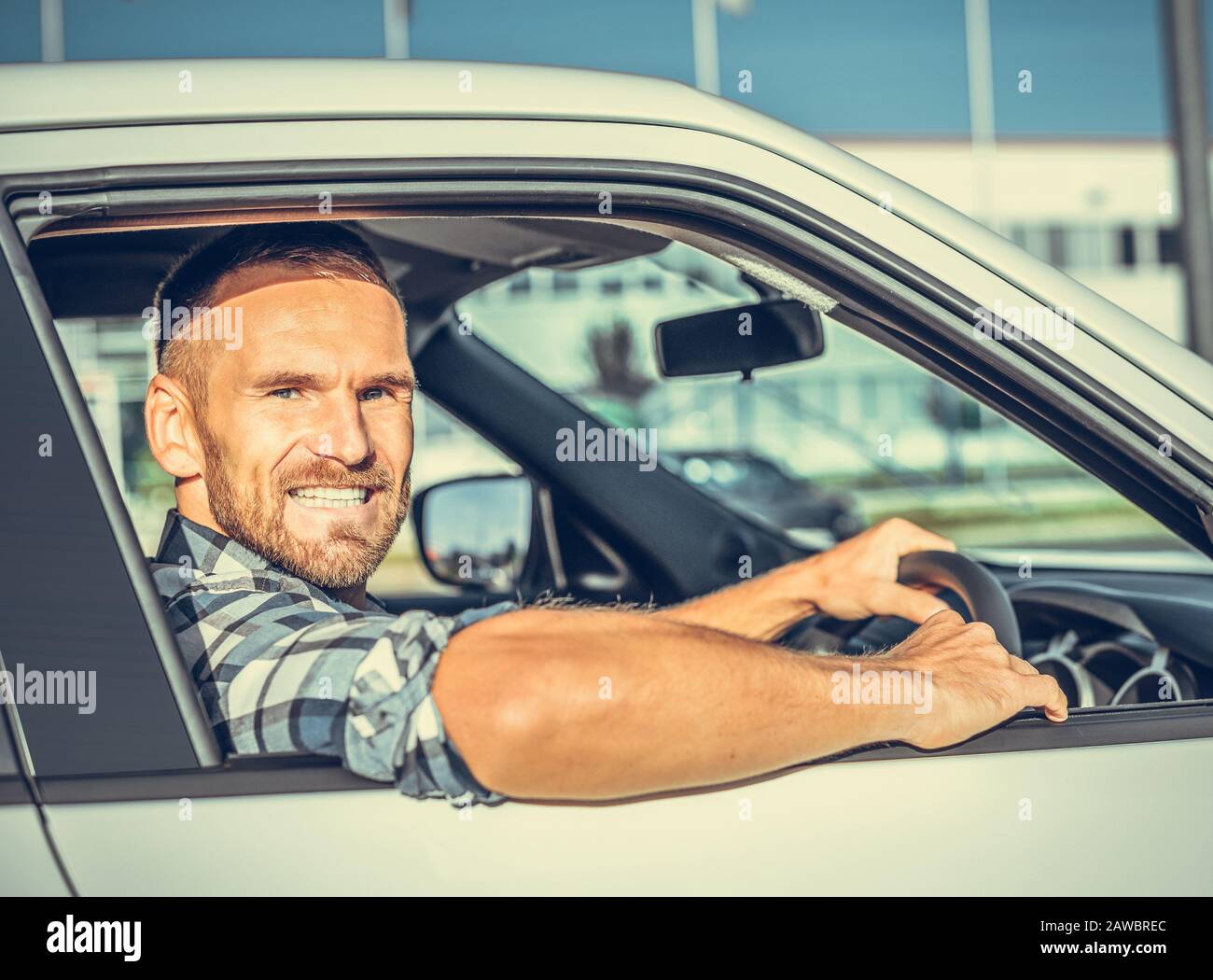 Attractive man driving a white car Stock Photo Alamy