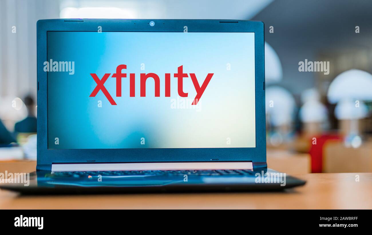 POZNAN, POL - DEC 11, 2019: Laptop displaying logo of Xfinity, a brand name of Comcast Cable Communications, LLC,  used to market consumer cable telev Stock Photo