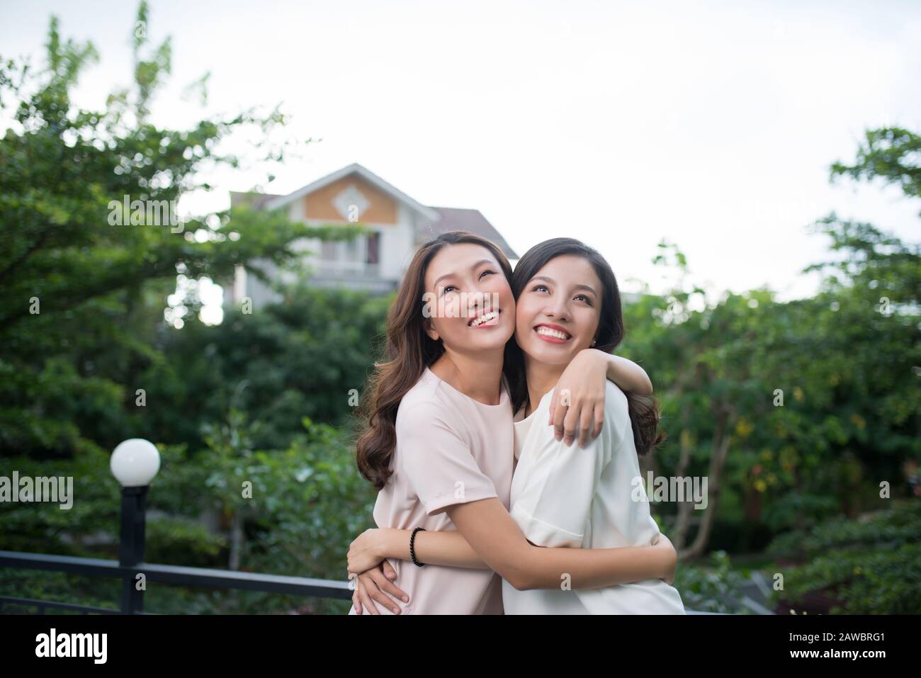 Two young Asian woman hugging in the balcony Stock Photo Alamy