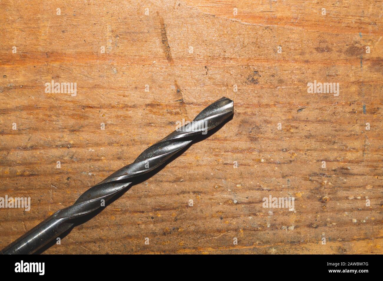 Drills on a wooden table. pile of drill bits on a wood background. work