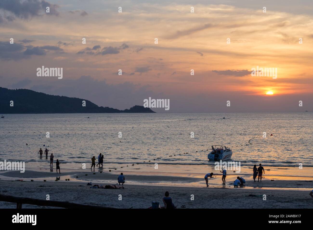 Sunset at Patong beach in Phuket. Phuket is large island and a popular travel destination in southern Thailand. Stock Photo