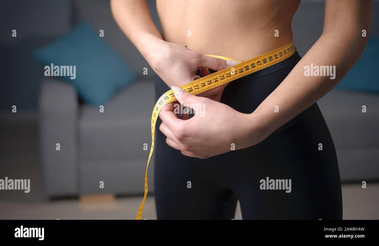 Woman hands measuring waist Stock Photo