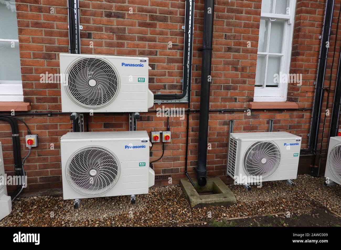 Martlesham Heath, Suffolk, UK - 8 February 2020: Outside wall mounted Panasonic R32 refridgerant air conditioning units on an office building Stock Photo