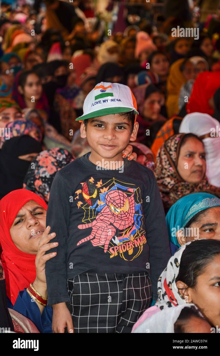 New Delhi, INDIA. January 25, 2020. Women Protest at Shaheen Bagh against CAA & NRC. A boy standing wearing a Tricolor cap at the protesting venue. Stock Photo