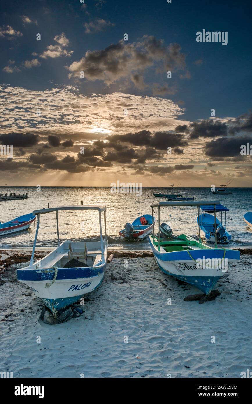 Fishing boats at sunrise, Caribbean Sea beach in Puerto Morelos, Riviera Maya, Yucatan Peninsula, Quintana Roo state, Mexico Stock Photo
