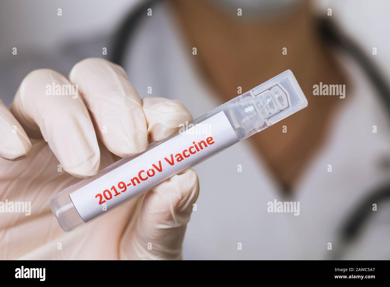 Doctor holds in his hand an ampoule with a coronavirus vaccine, close-up Stock Photo