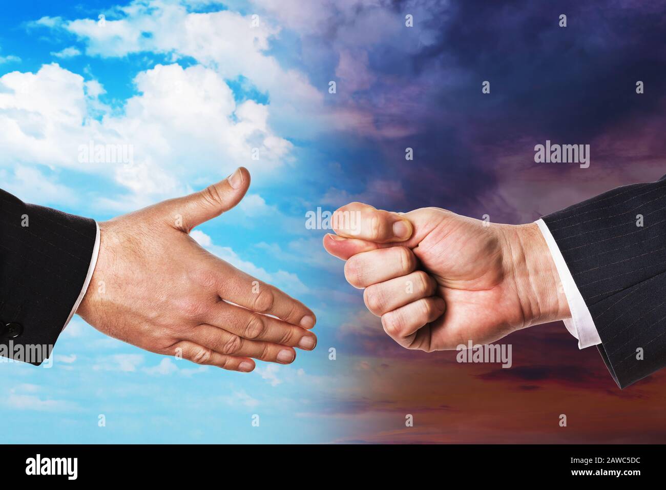 Two hands on a background of the sky with clouds. Concept on offering friendship and refusal Stock Photo