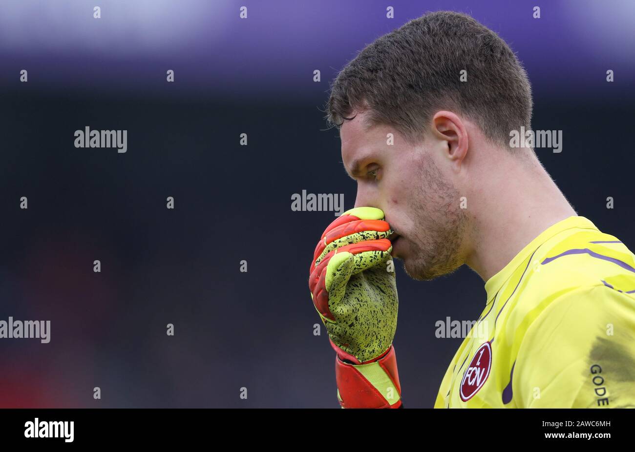 08 February 2020, Lower Saxony, Osnabrück: Football: 2nd Bundesliga, VfL Osnabrück - 1 FC Nürnberg, 21st matchday in the stadium at Bremer Brücke. Goalkeeper Christian Mathenia from Nuremberg grabs his nose. Photo: Friso Gentsch/dpa - IMPORTANT NOTE: In accordance with the regulations of the DFL Deutsche Fußball Liga and the DFB Deutscher Fußball-Bund, it is prohibited to exploit or have exploited in the stadium and/or from the game taken photographs in the form of sequence images and/or video-like photo series. Stock Photo