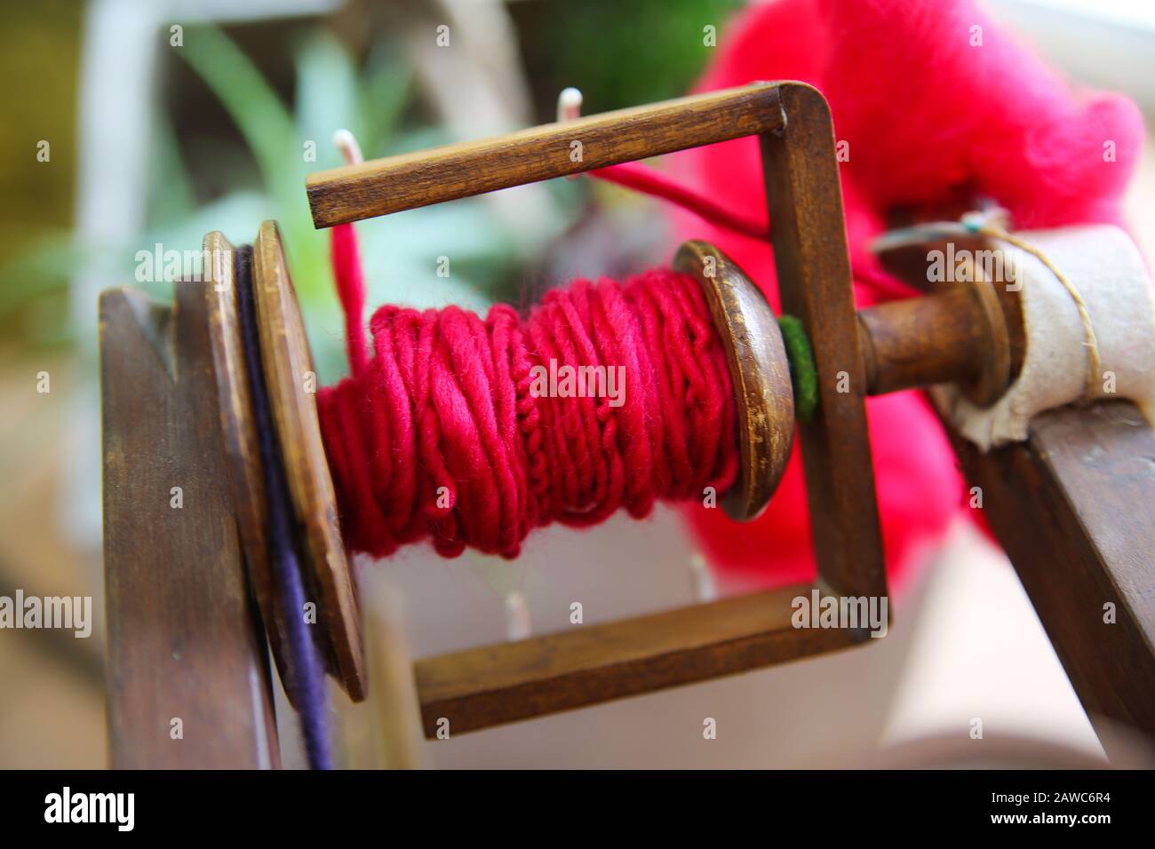 Two antique wooden spinning wheels, also called knitting yarn winders, used  to spin wool into yarn Stock Photo - Alamy