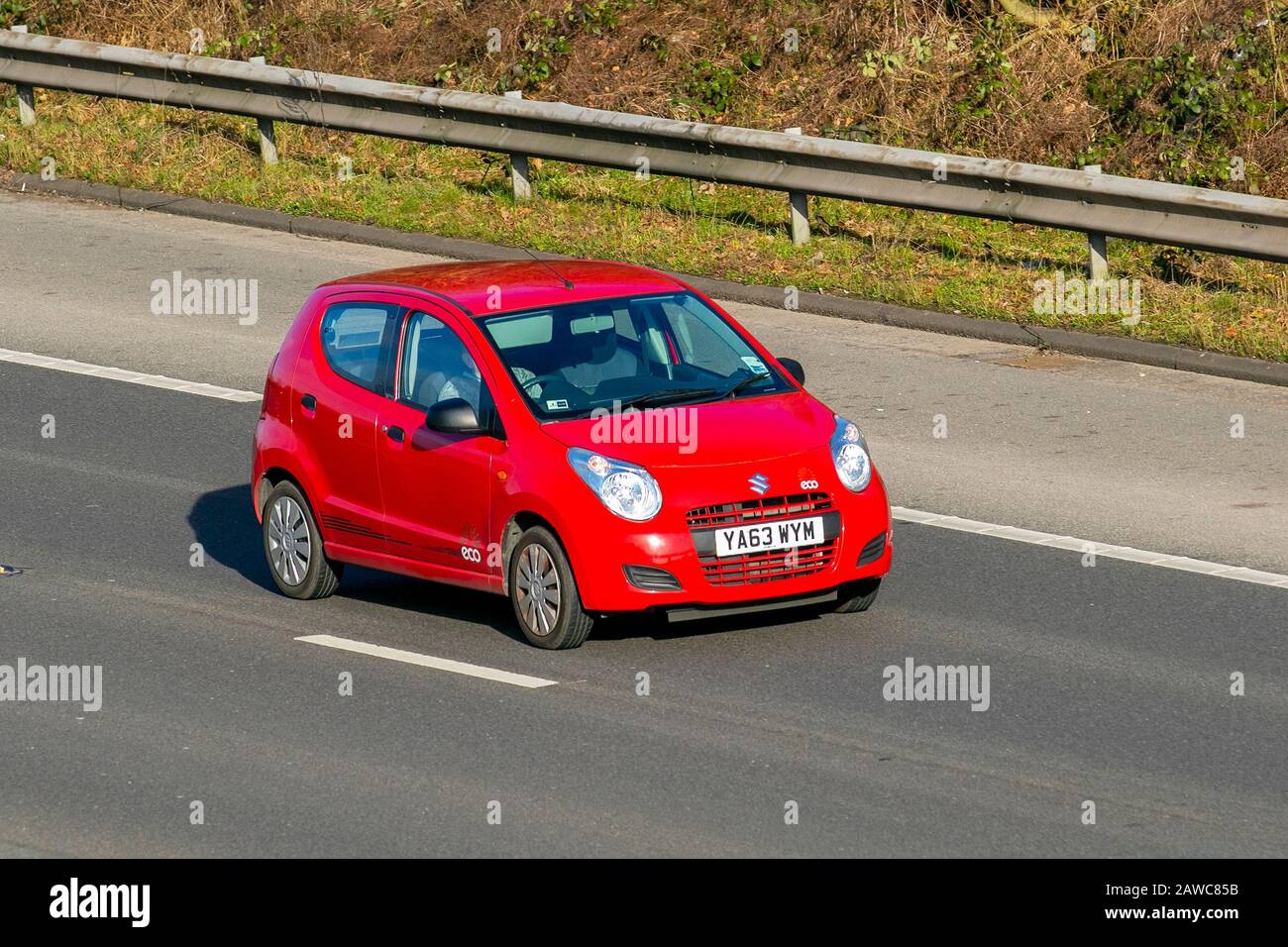 2014 red Suzuki Alto SZ; UK Vehicular traffic, transport, modern, saloon cars, on the M61 motorway highway. UK Stock Photo