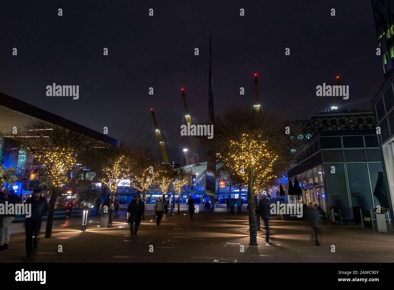 The exterior of the O2 Millennium Dome in North Greenwich, London with winter lights in the trees Stock Photo
