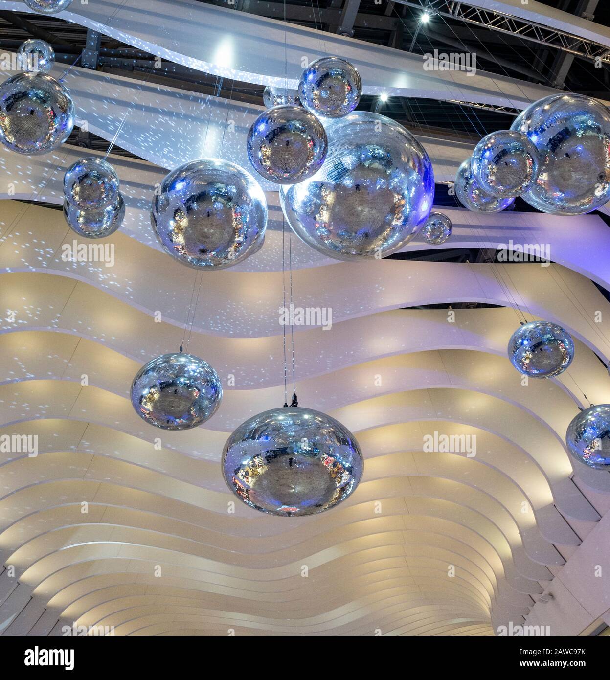 Large silver balls hang from the ceiling of the walkways of the Millennium Dome in London Stock Photo