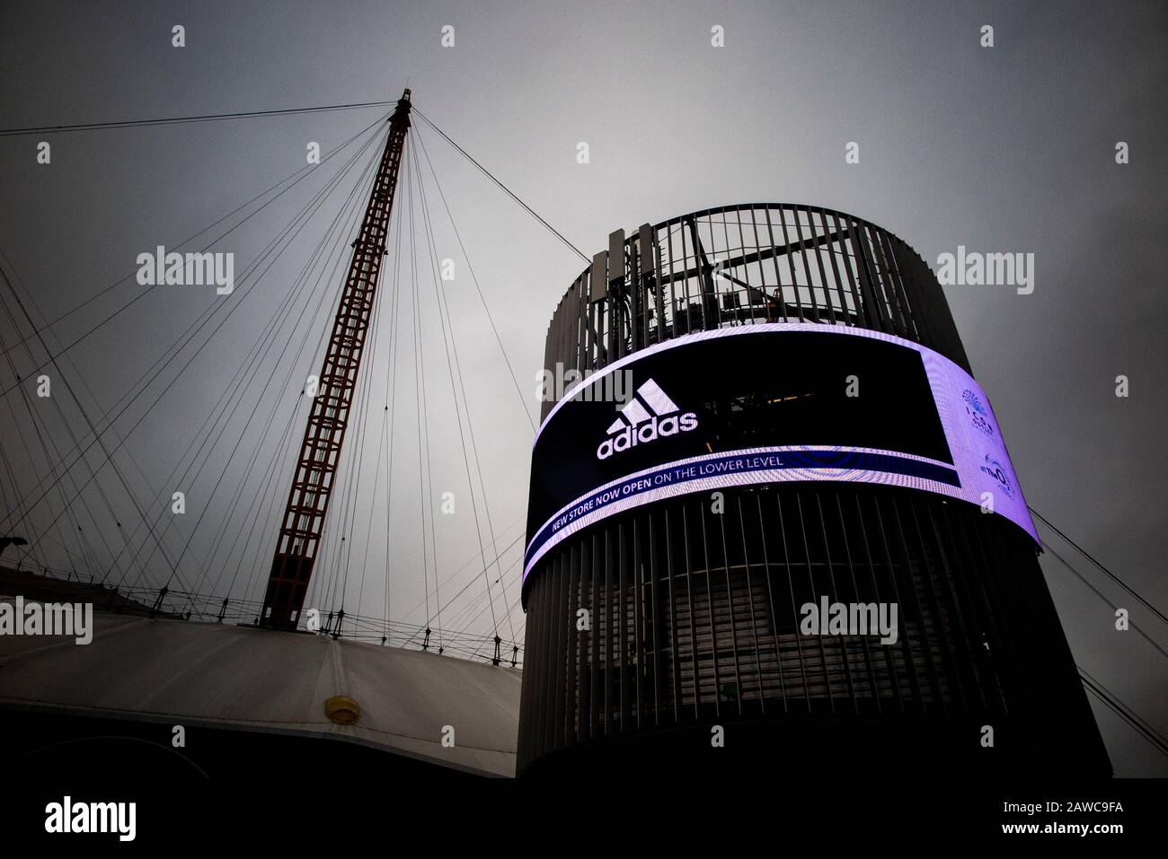 The exterior of the O2 Millennium Dome in North Greenwich, London with an electronic advertising hoarding from Adidas Stock Photo