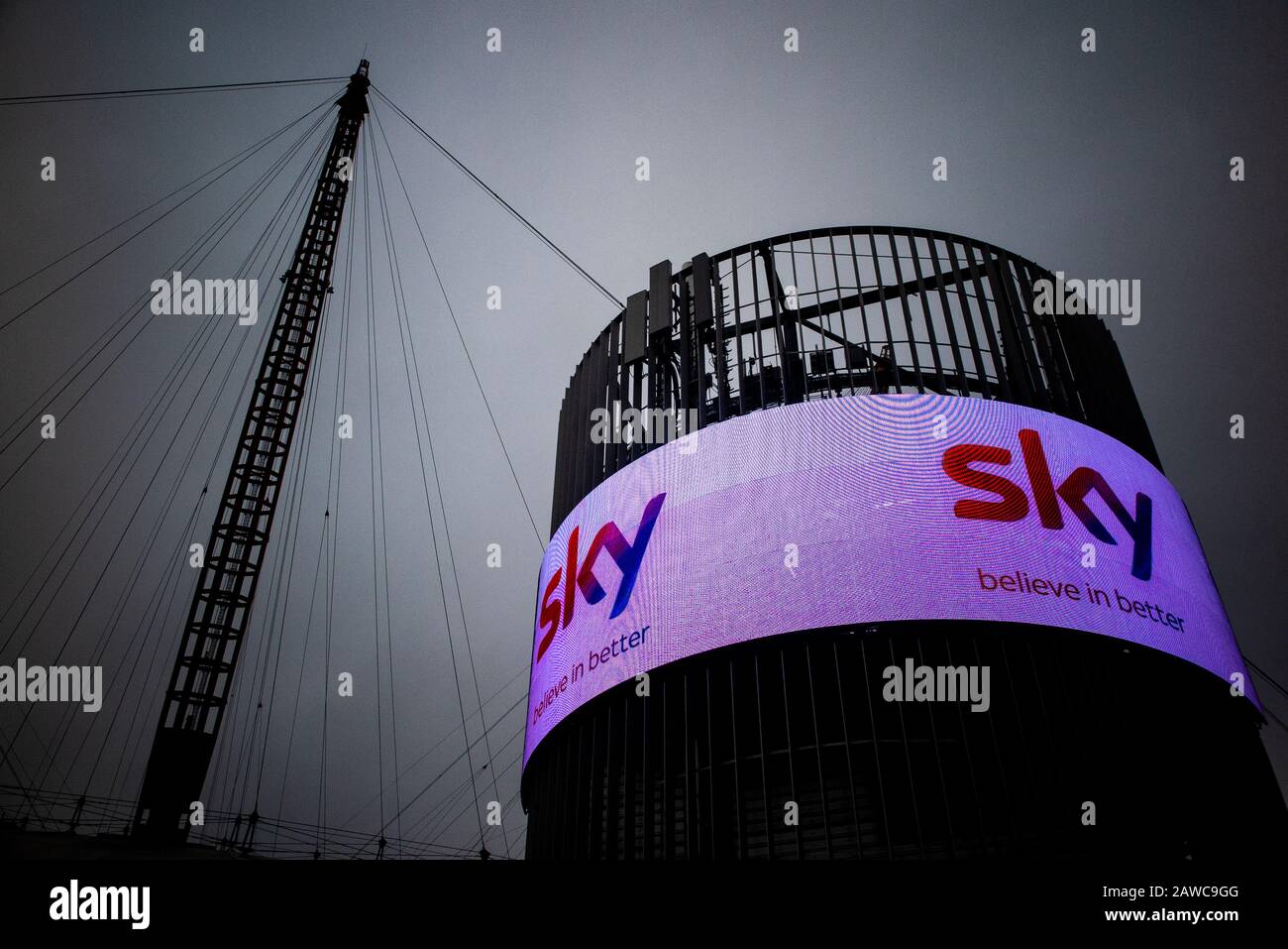 The exterior of the O2 Millennium Dome in North Greenwich, London with an electronic advertising hoarding from Sky Stock Photo