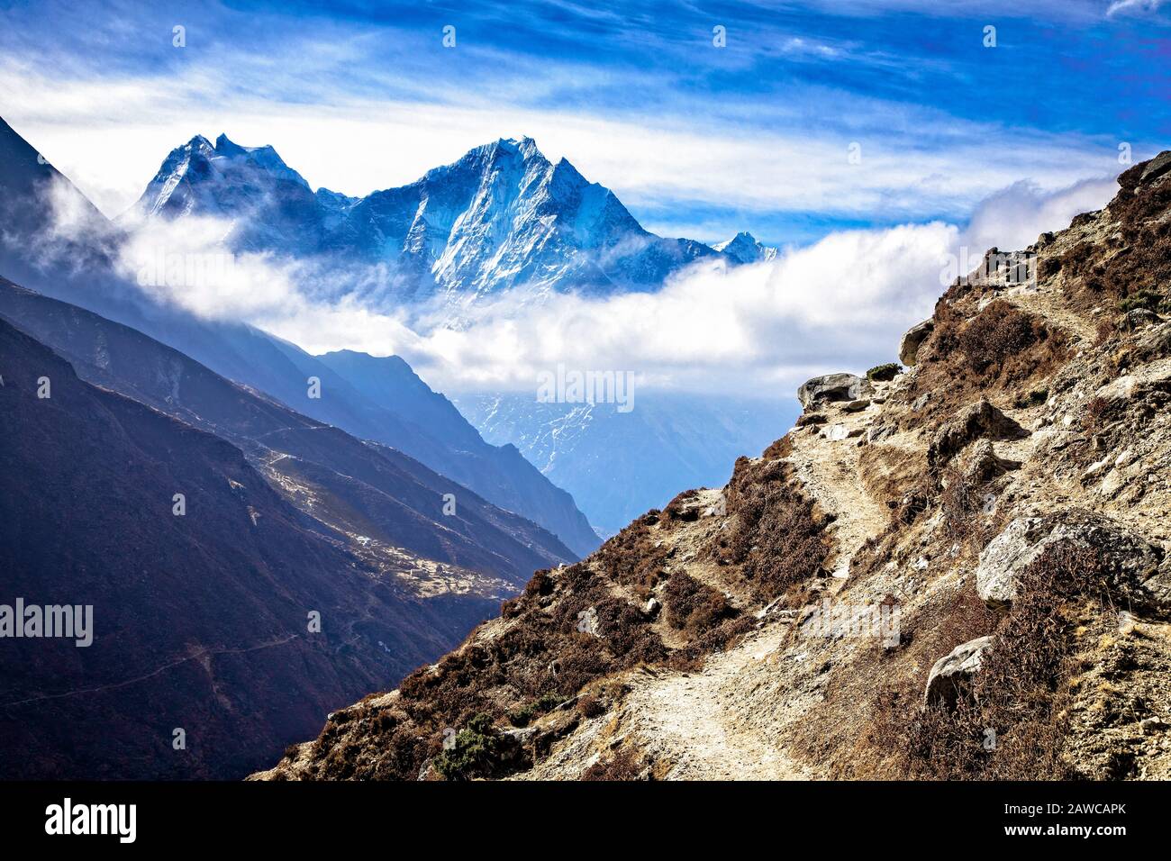 The trail to Gokyo with Kangtega (6685 meters) and Thamserku (6608 meters) in the background.  Sagarmatha National Park, Nepal. Stock Photo