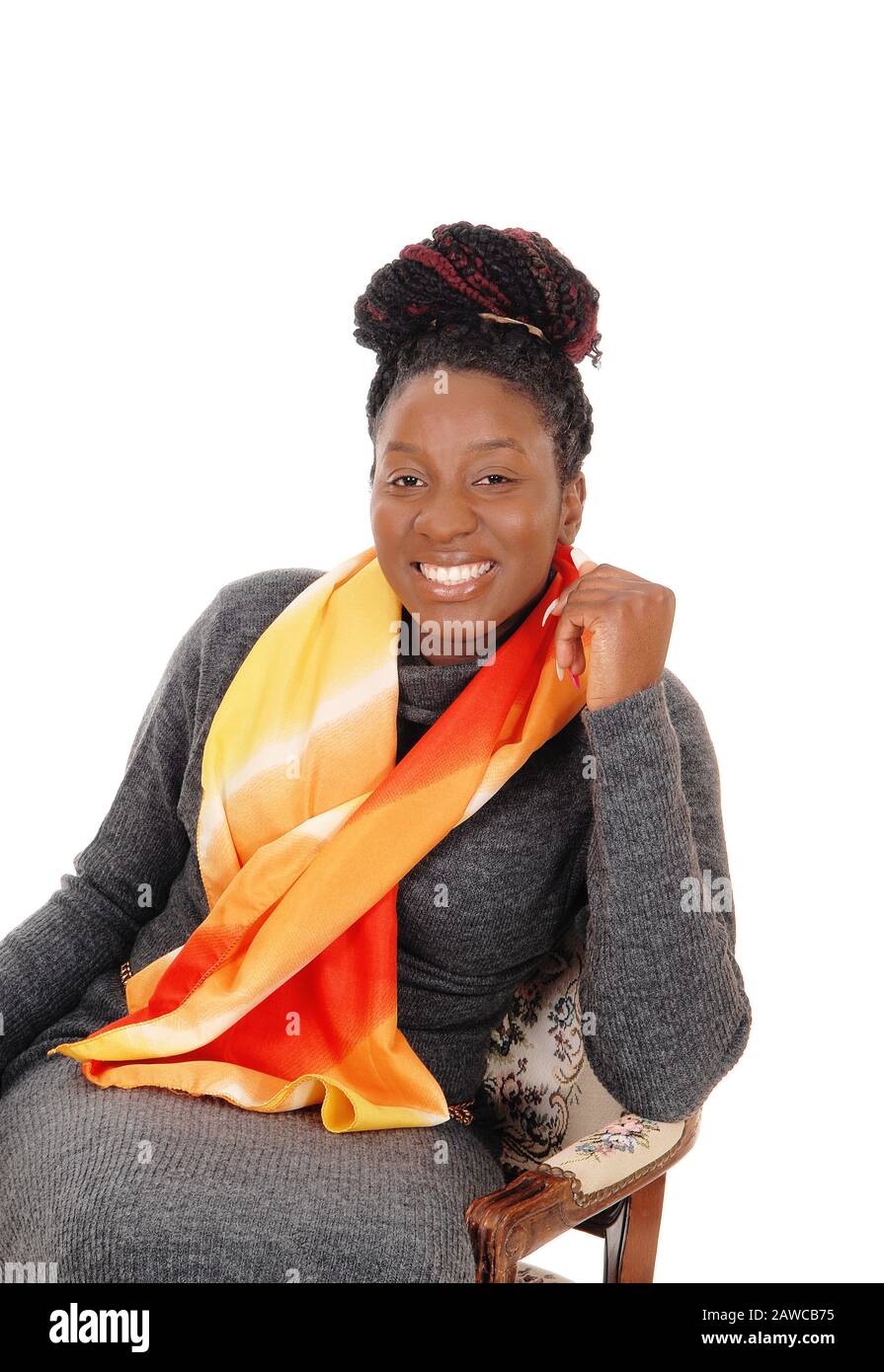 A beautiful African American woman sitting in a chair with a colorful ...