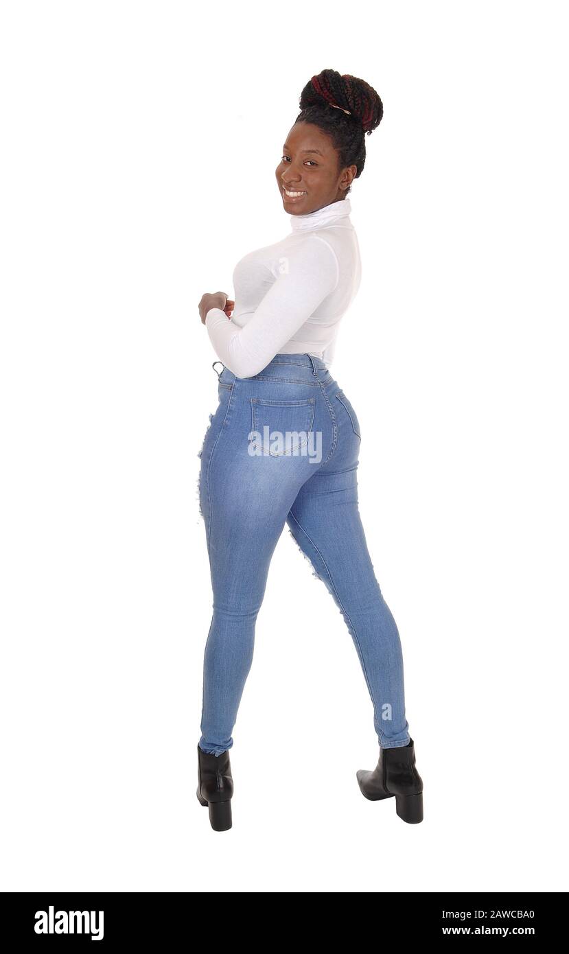 A gorgeous young woman standing in jeans and white top from the back, looking over shoulder, isolated for white background Stock Photo
