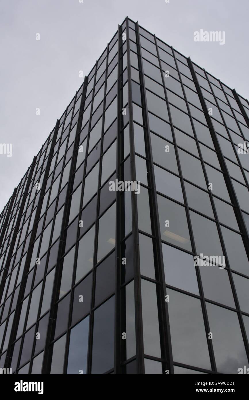 Office building with windows reflecting trees and sky Stock Photo - Alamy