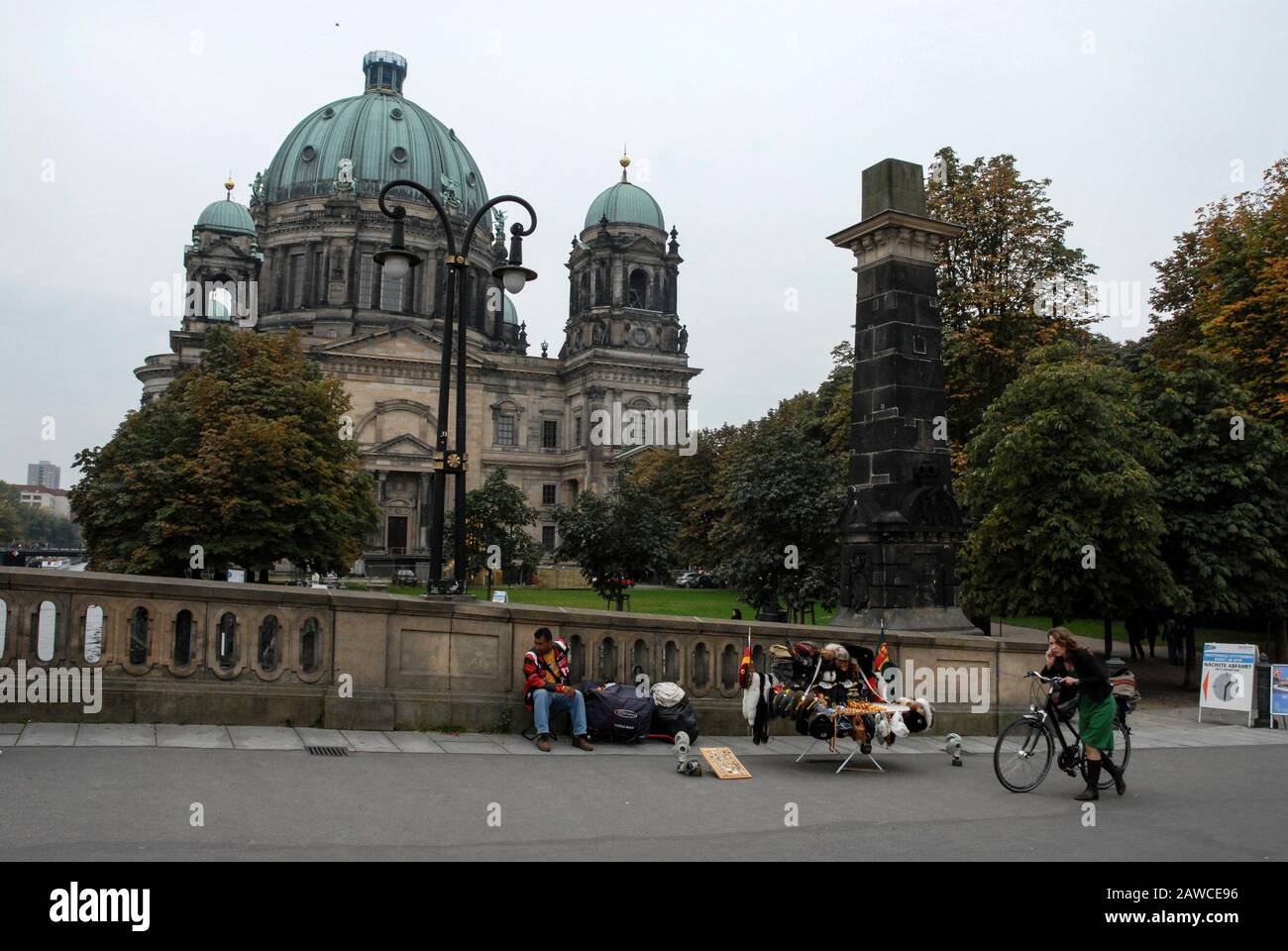 A street hawker with his East German and Russian military souvenir stall near the Berliner Dom (Berlin Cathedral)  on the banks of the River Spree in Stock Photo