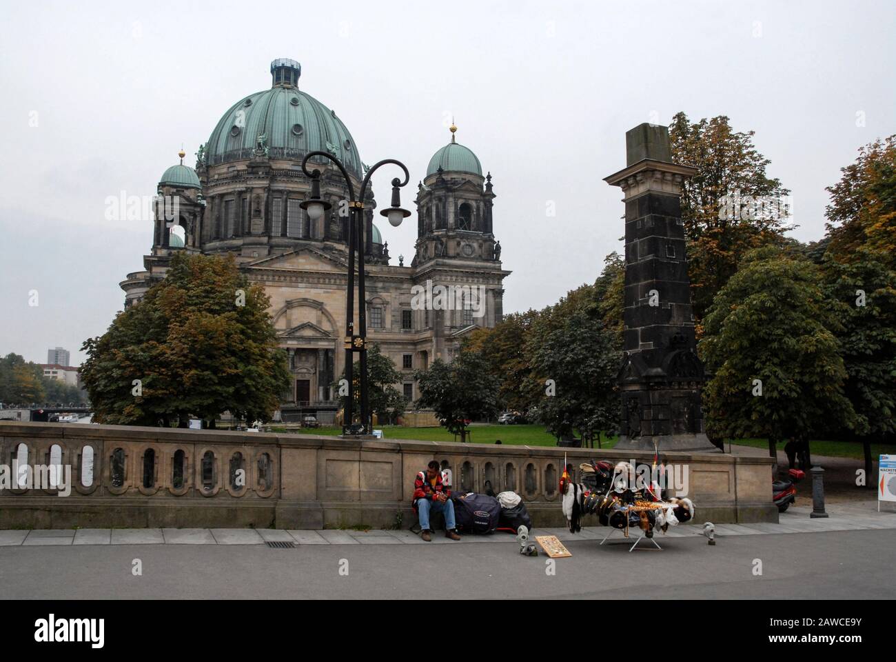 A street hawker with his East German and Russian military souvenir stall near the Berliner Dom (Berlin Cathedral)  on the banks of the River Spree in Stock Photo