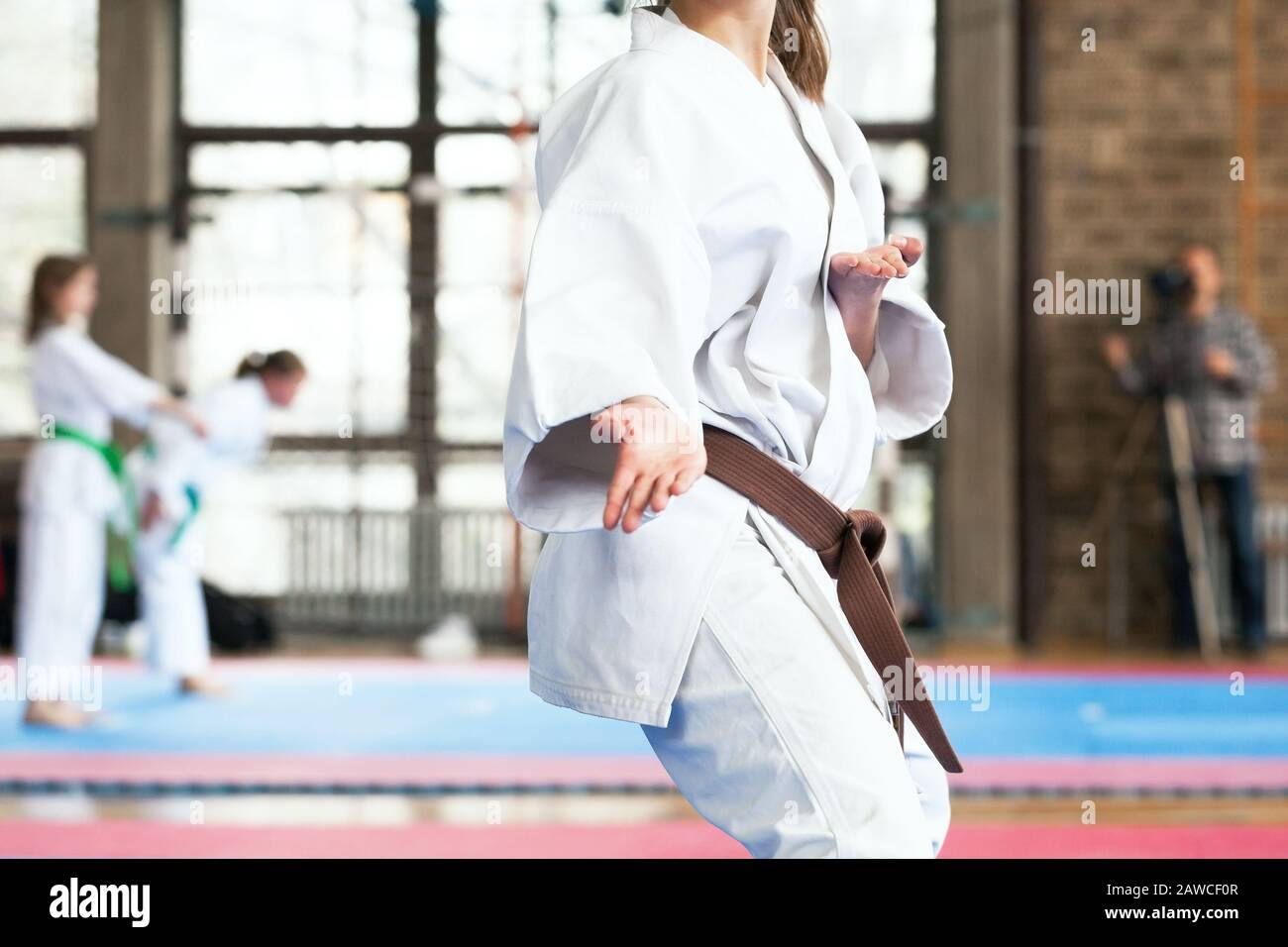 Karate brown belt practitioner body position during competition Stock Photo
