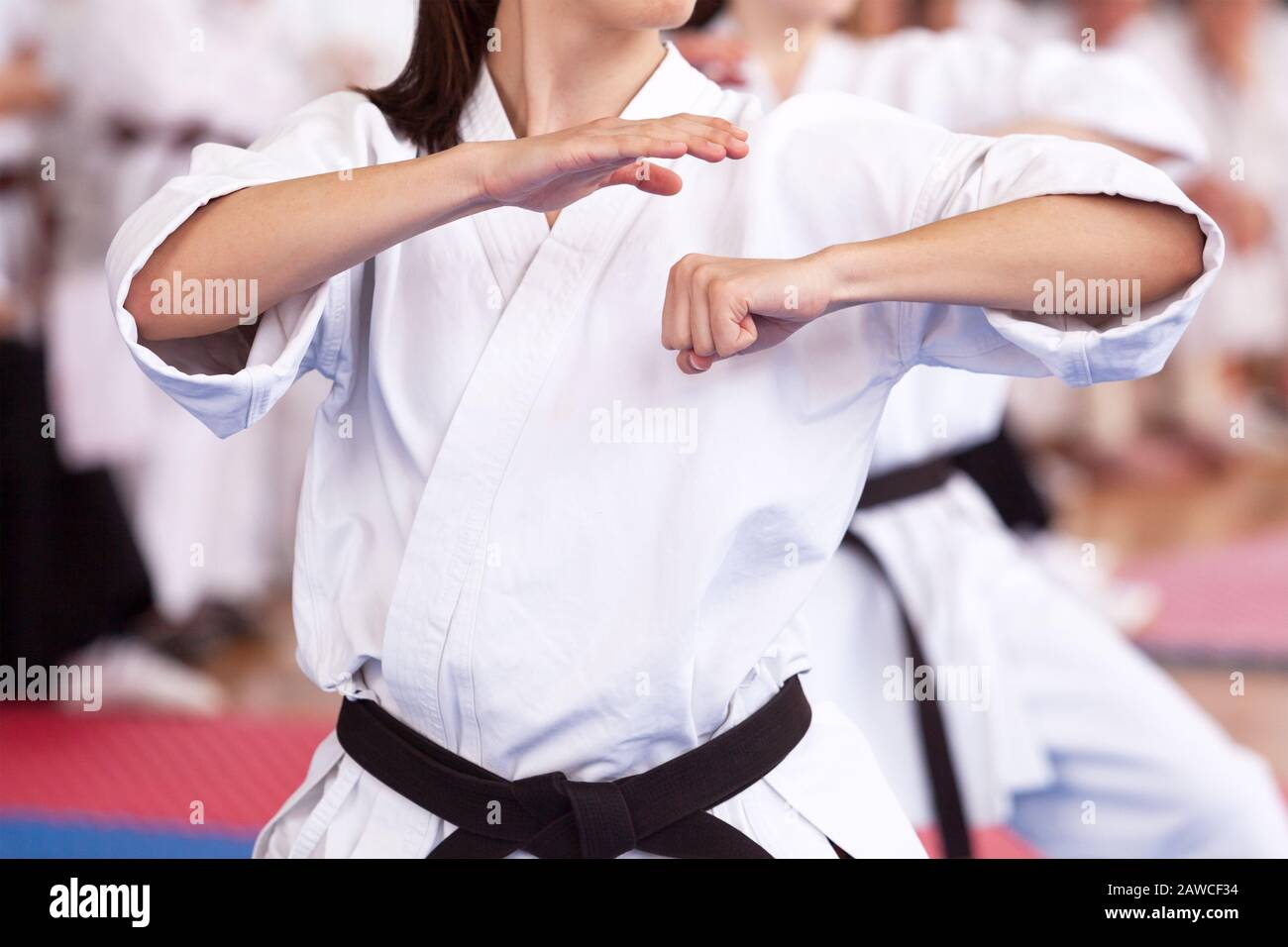 Female karate black belt practitioner body position during class Stock Photo