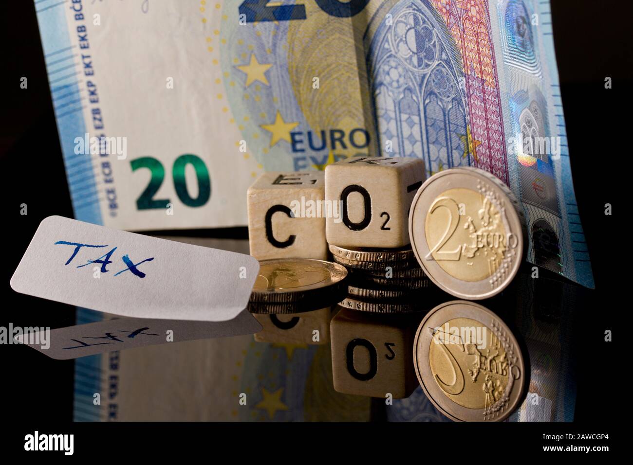 CO2-Abgabe und CO2-Steuer, CO2-certificates symbolized by money, letters and reflexion refexions Stock Photo