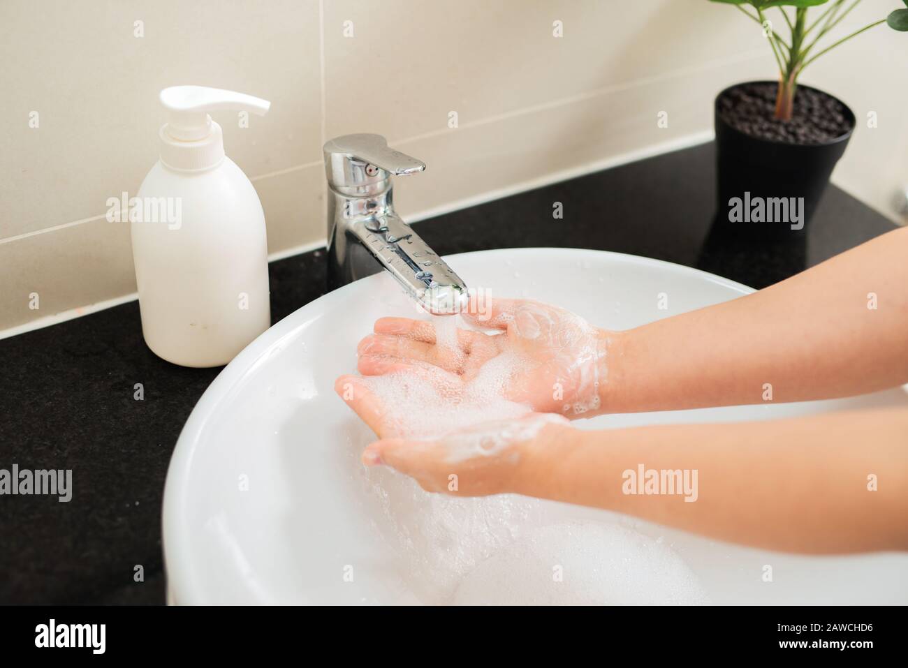 Washing of hands with soap under running water Stock Photo - Alamy