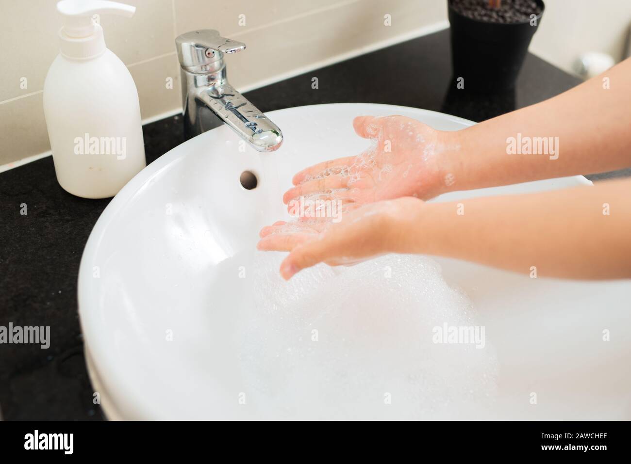 Washing of hands with soap under running water Stock Photo - Alamy