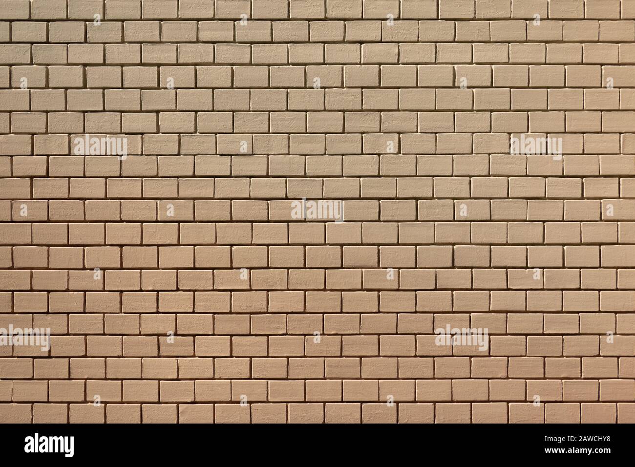 Old brick wall painted over in light brown Stock Photo