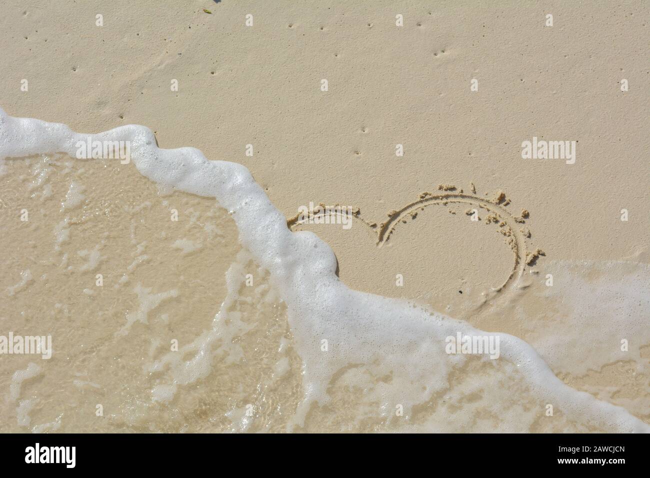 Heart Wrote In The Sand And Washed Away By Waves Stock Photo Alamy