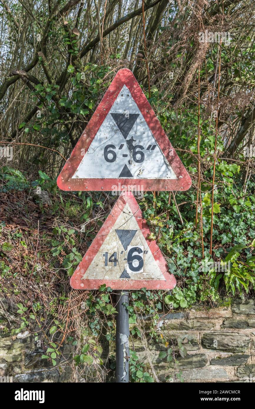 UK bridge clearance height warning sign. Low bridge concept, red triangle warning signs, UK road signs in general. Stock Photo