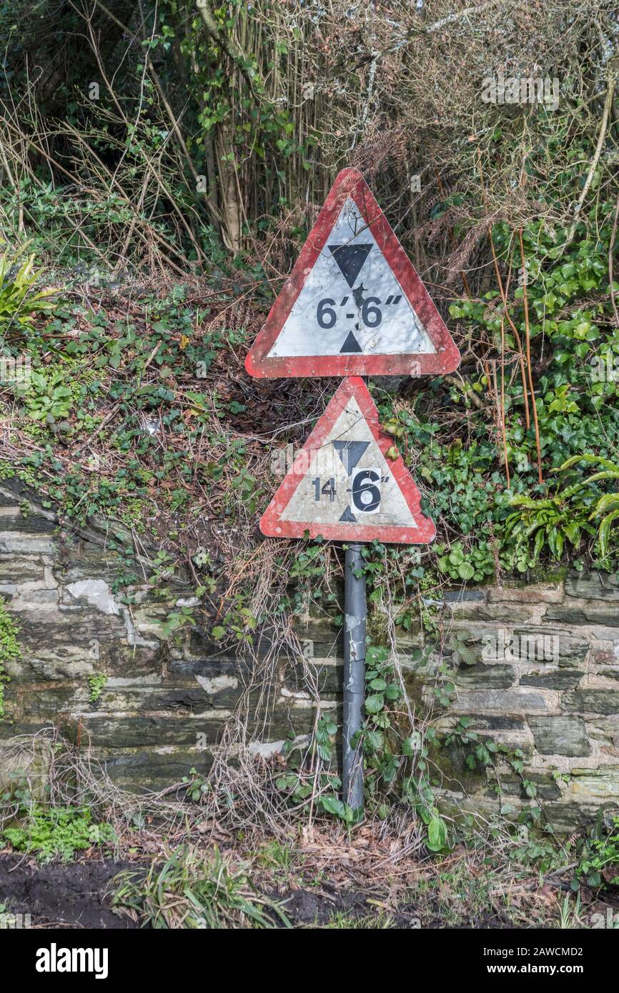 UK bridge clearance height warning sign. Low bridge concept, red triangle warning signs, UK road signs in general. Stock Photo