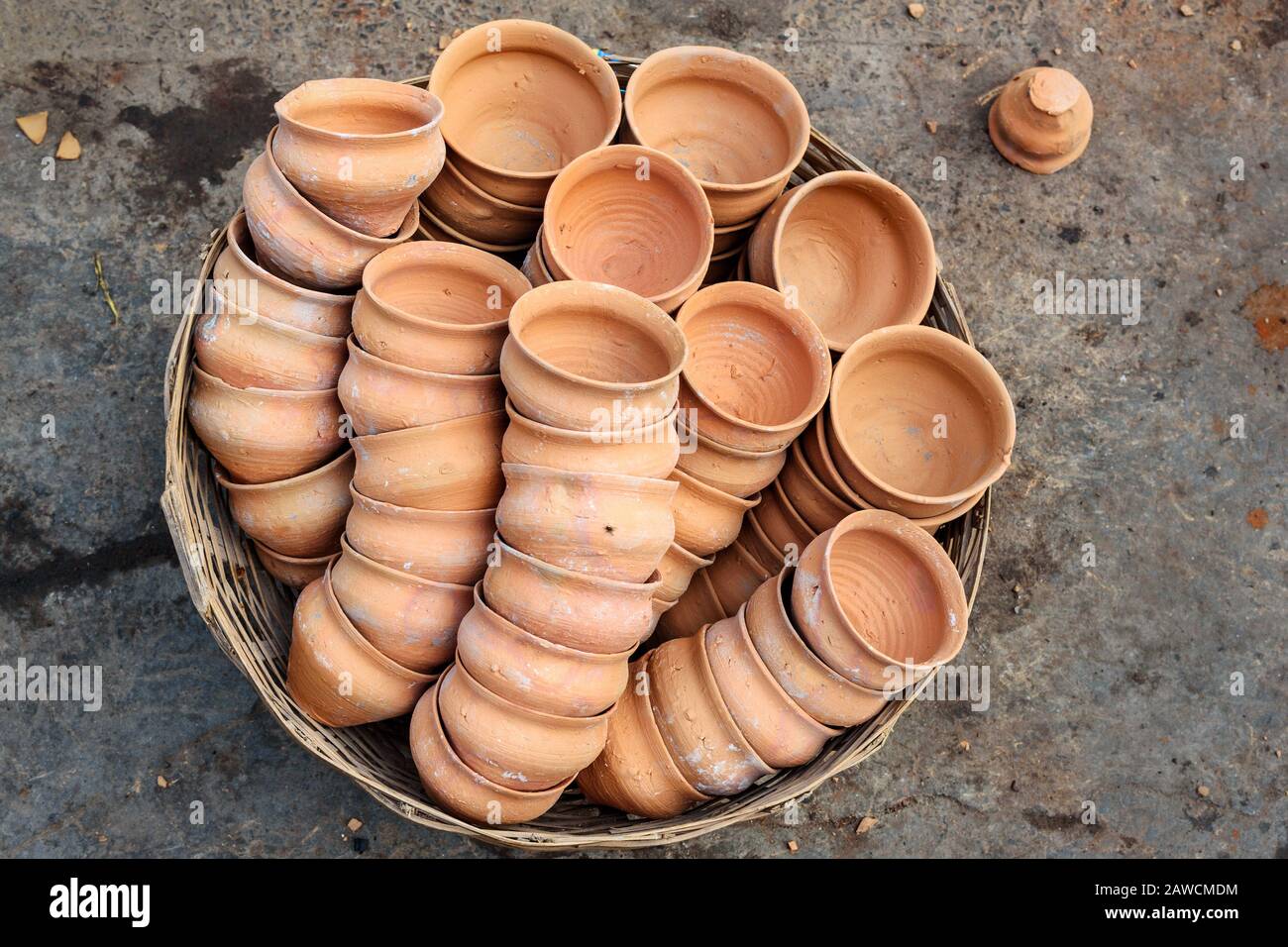 Clay cups in basket on the street. Kolkata. India Stock Photo