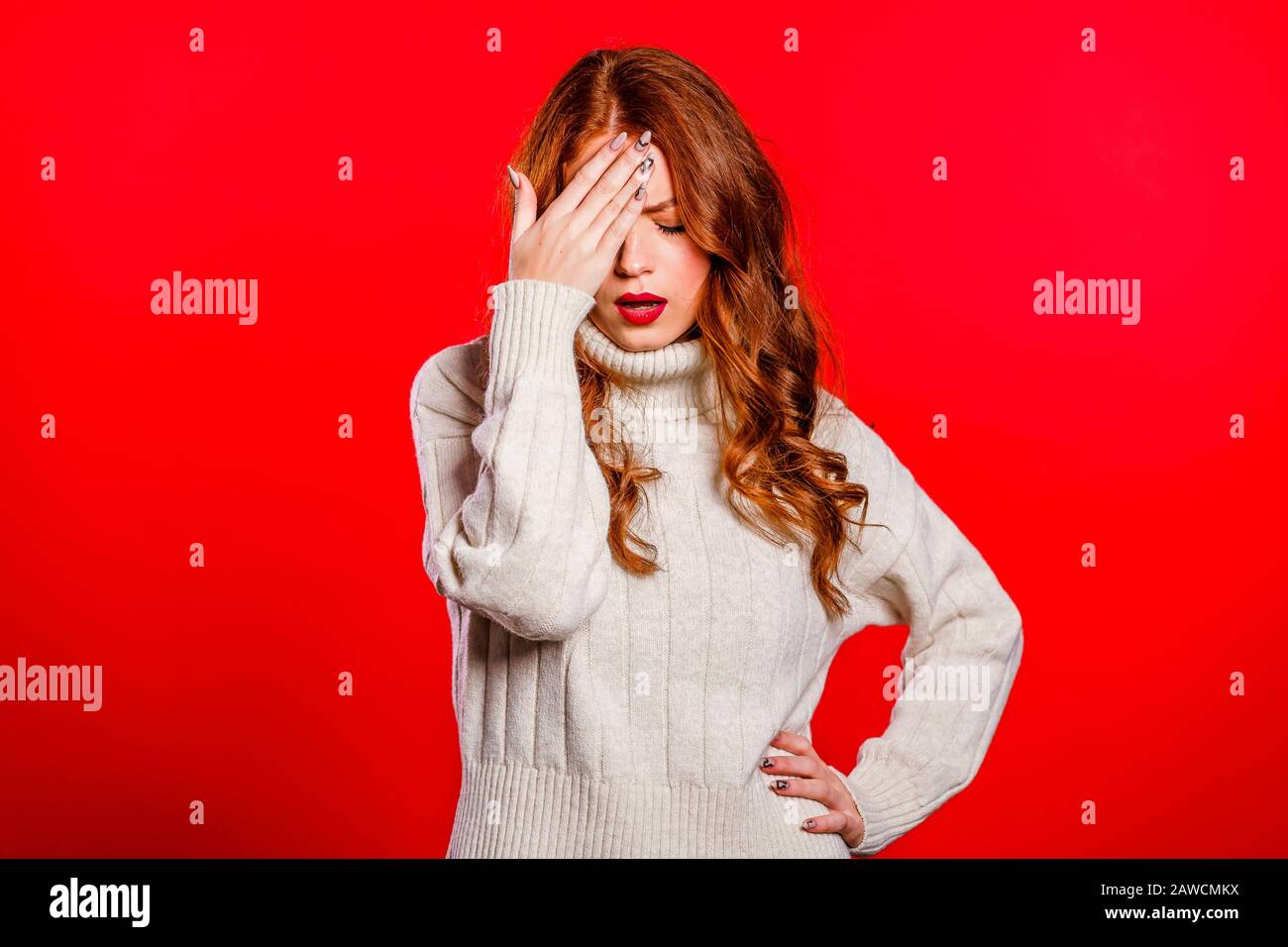 Portrait of forgetful woman. Pretty girl holding hand on head like ...