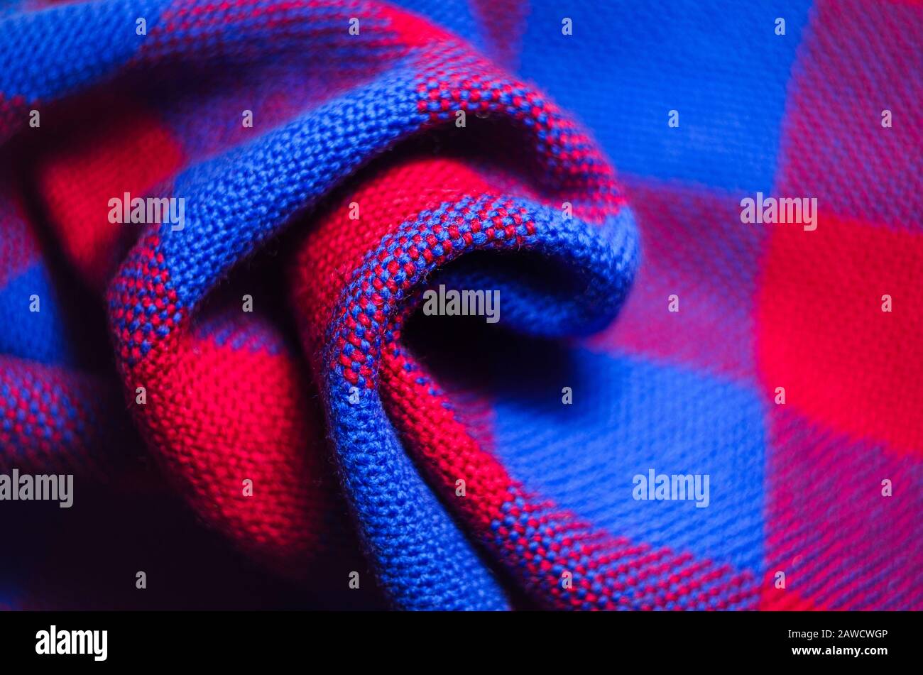 Plaid material. Red and blue cage clothes. Crumpled twisted fabric background Stock Photo