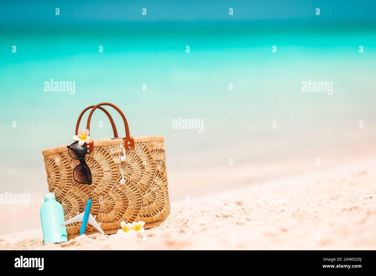 Beach accessories straw bag, hat and unglasses on the beach Stock