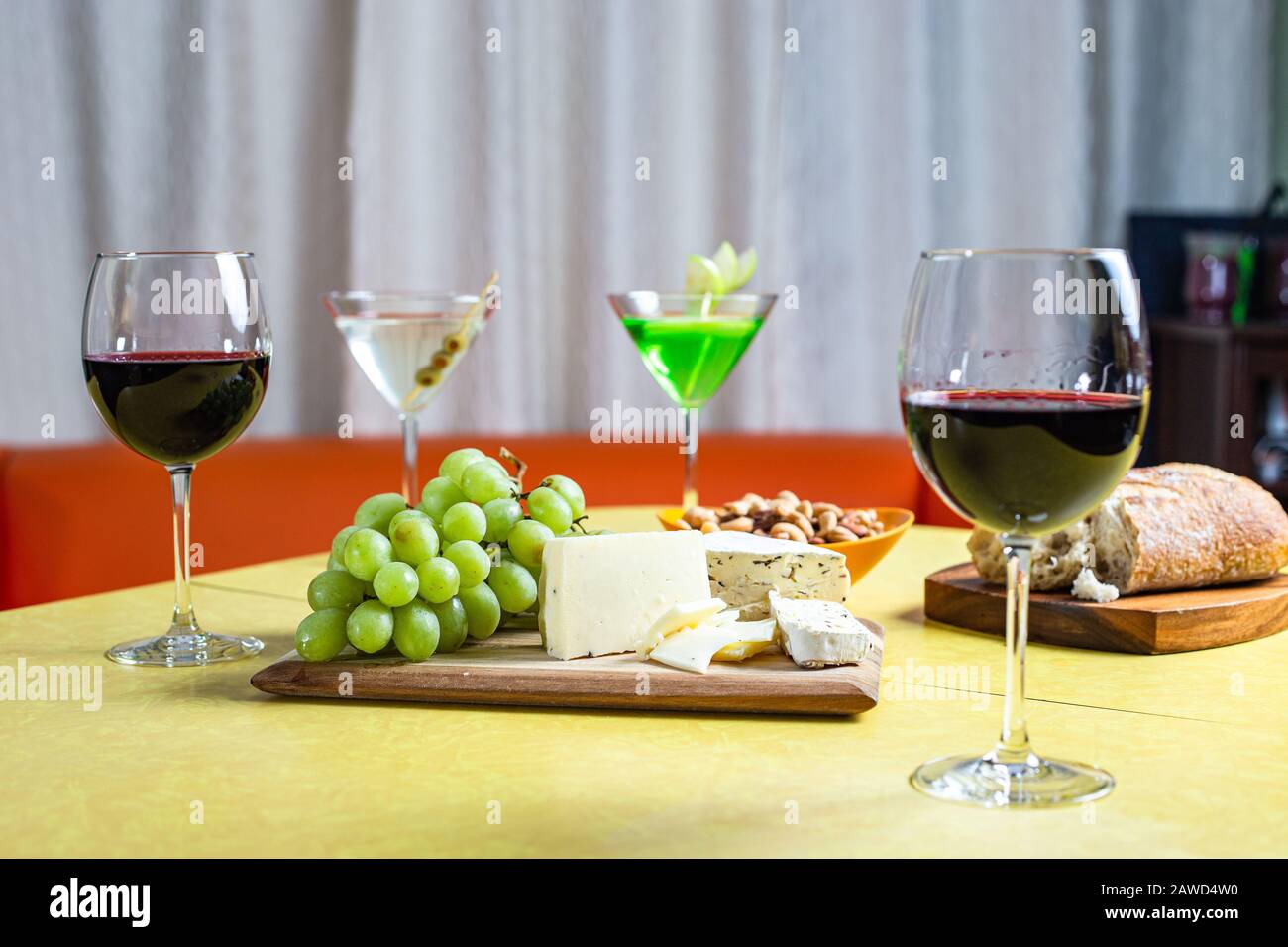 Wine and cheese pairing with colorful yellow and orange background Stock Photo