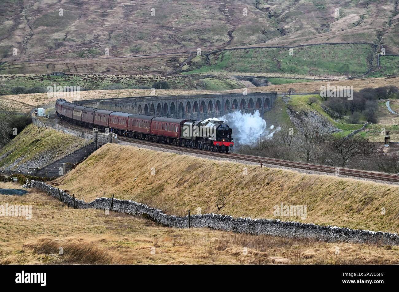 Ribblehead, North Yorkshire, UK. 8th January, 2020.The 'Winter Cumbrian Mountain Express' steam special hauled by 46115 'Scots Guardsman' is seen here crossing the famous Ribblehead viaduct in the Yorkshire Dales National Park, travelling south from Carlisle on the famous Settle to Carlisle railway line. Credit: John Bentley/Alamy Live News Stock Photo