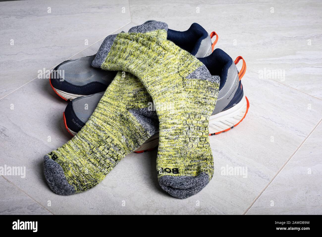 Yellow Bombas calf socks shown with athletic shoes. weave of