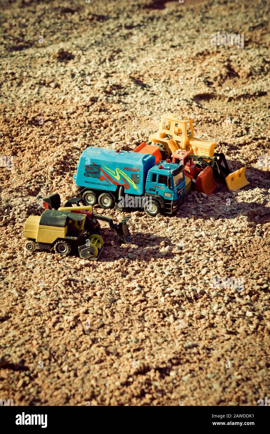 plastic children toys abandoned in a sandpit Stock Photo