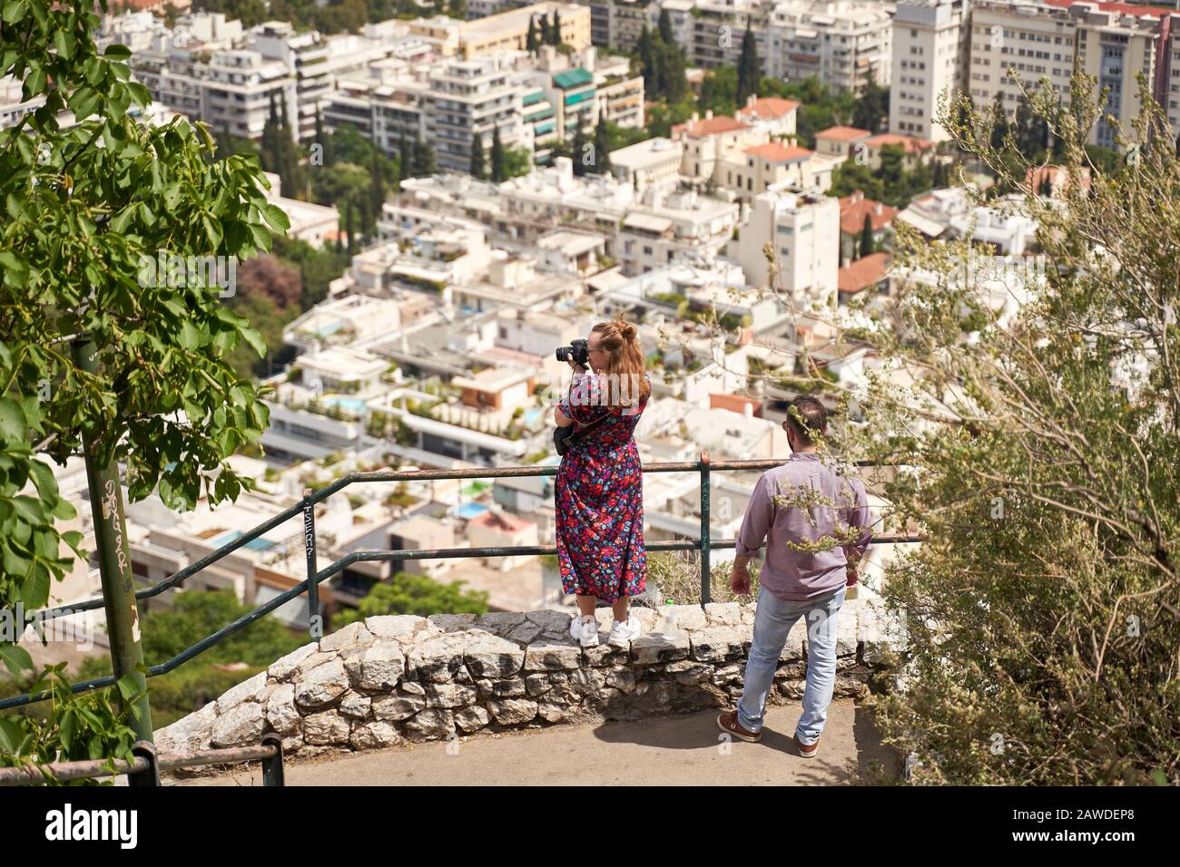 ATHENS, GREECE - MAY 18, 2019: tourists photographing city panorama of Athens, Greece in summer season Stock Photo