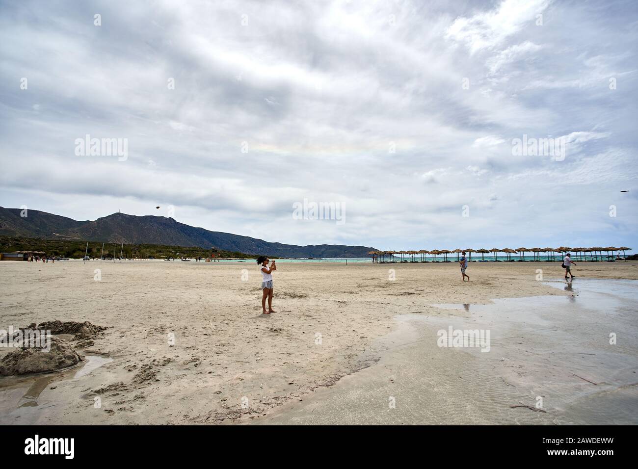 CRETE, GREECE - MAY 19, 2019:  tourists enjoy amazing Elafonissi Beach in Crete island, Greece. Scenic Spot is known for its pink sand beaches. Beauti Stock Photo