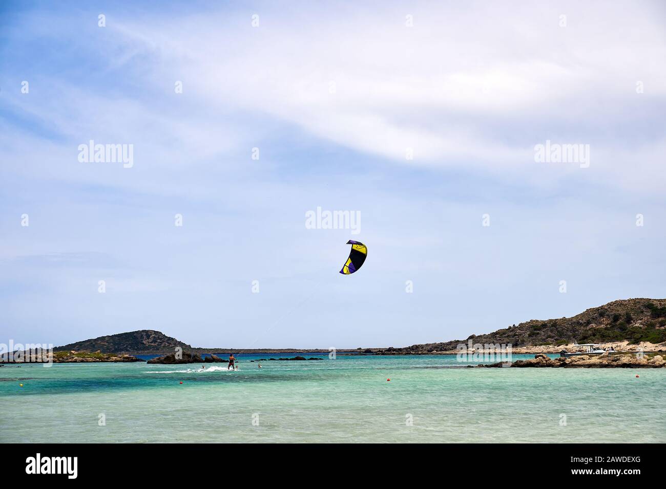 CRETE, GREECE - MAY 19, 2019:  tourists enjoy kite on amazing Elafonissi Beach in Crete island, Greece. Scenic Spot is known for its pink sand beaches Stock Photo
