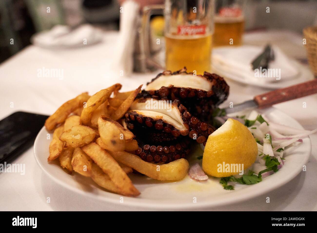 tradittional local octopuss meal food in a restaurant in Chania, Crete, Greece at night Stock Photo