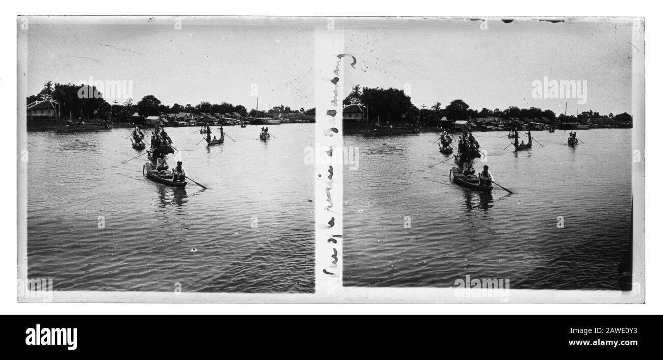 Battambang Cambodia local residents in traditional boats on Stung Sangker river in the 1910s, possibly Ton Lesap lake. Stereo view photo on a bromine silver gelatine glass plate. Contemporary caption in handwriting between the to pictures. Stock Photo