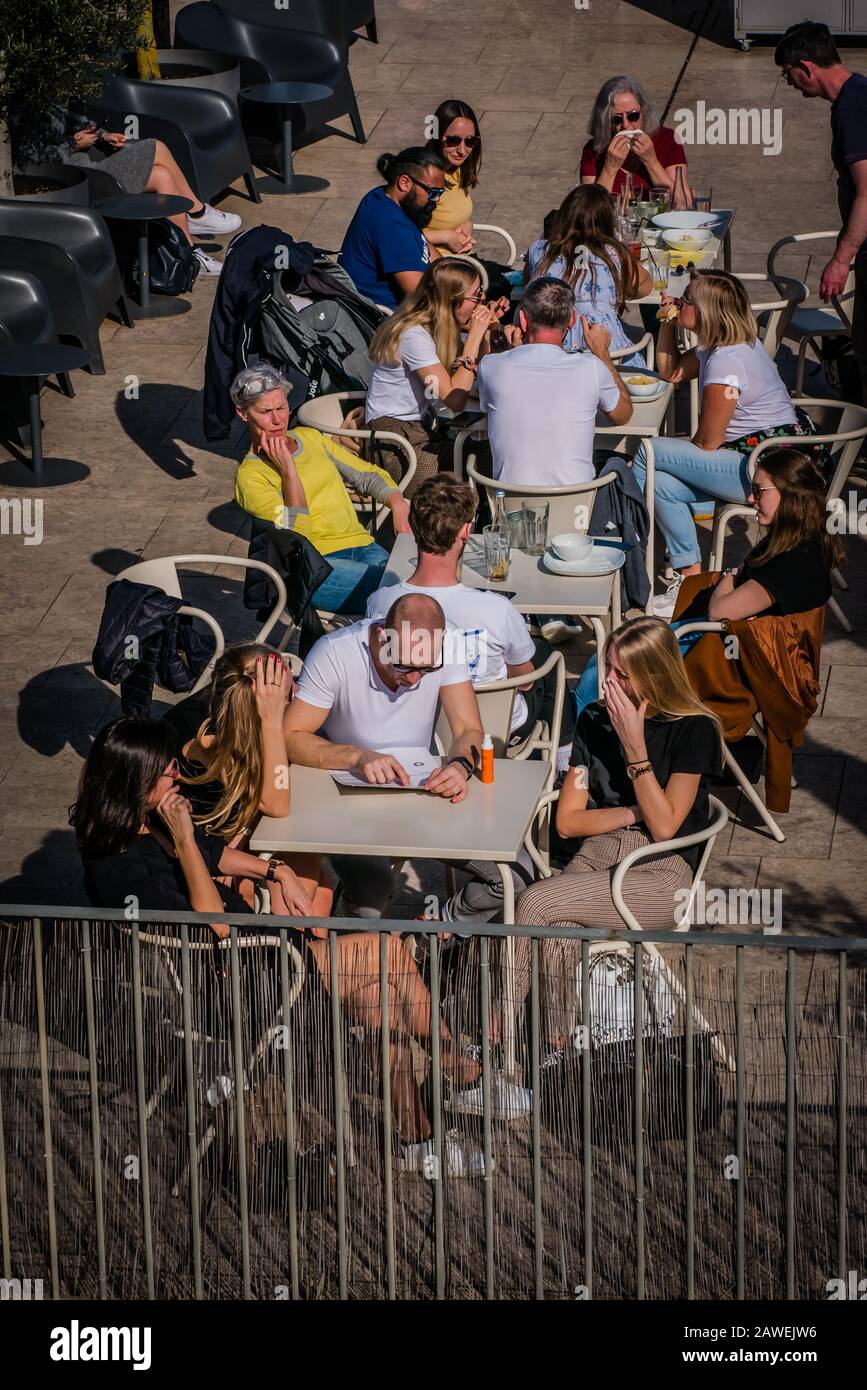 people enjoying outdoor patio under a sunny afternoon in Lisbon Stock Photo