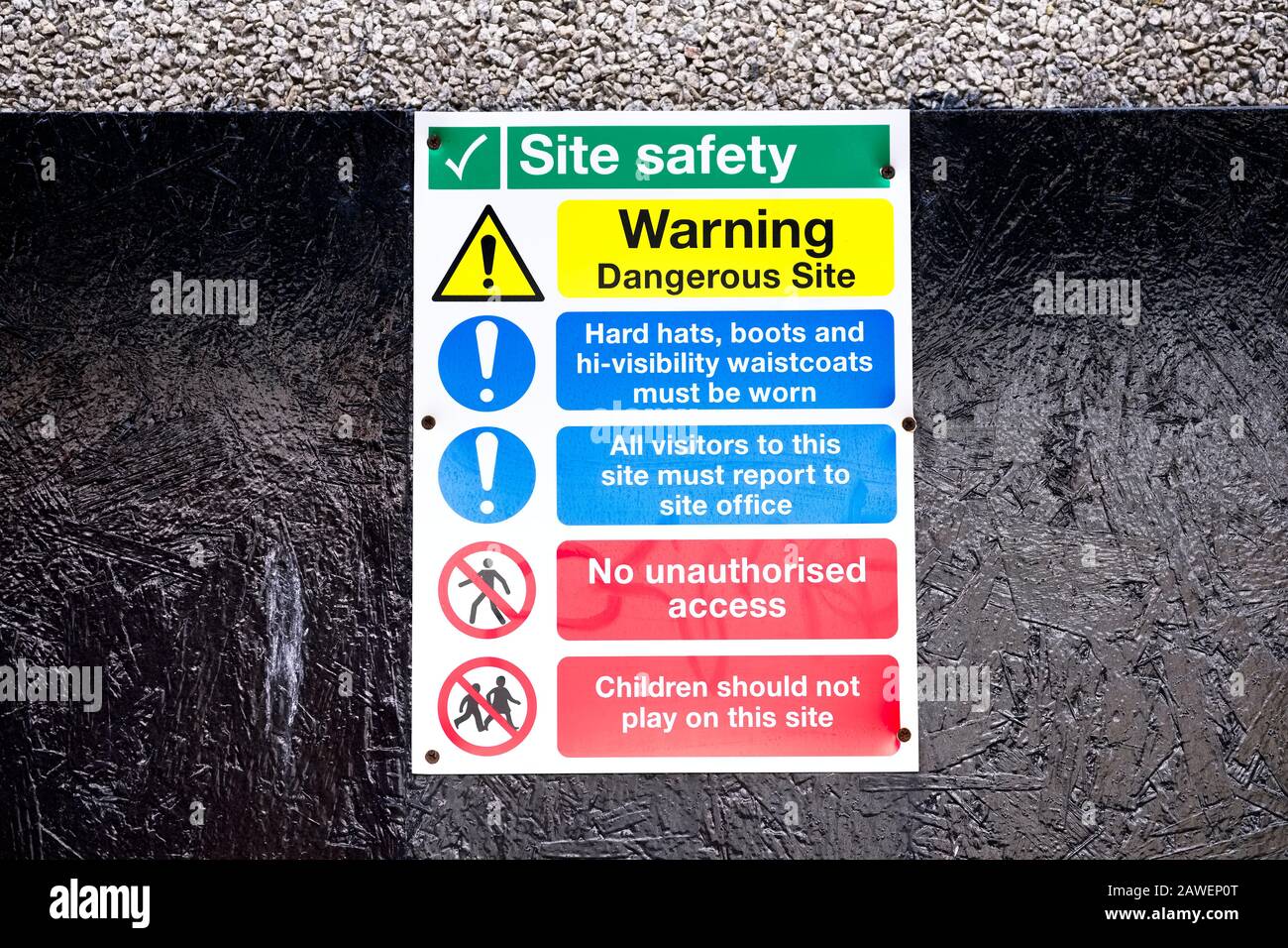 Construction site health and safety message rules sign board signage on boundary wall entrance