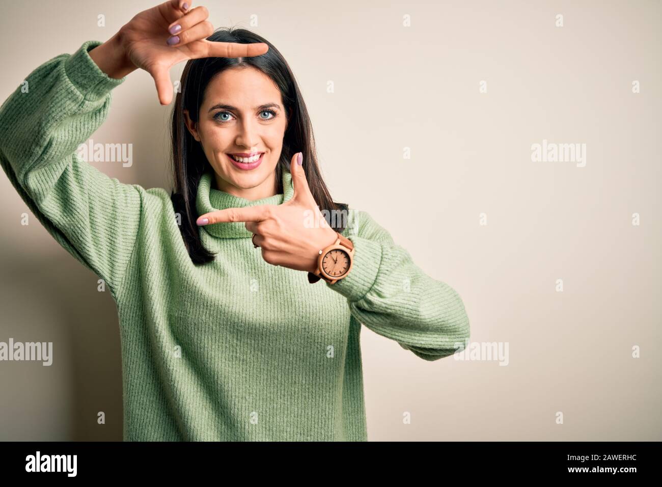 Young brunette woman with blue eyes wearing turtleneck sweater over ...